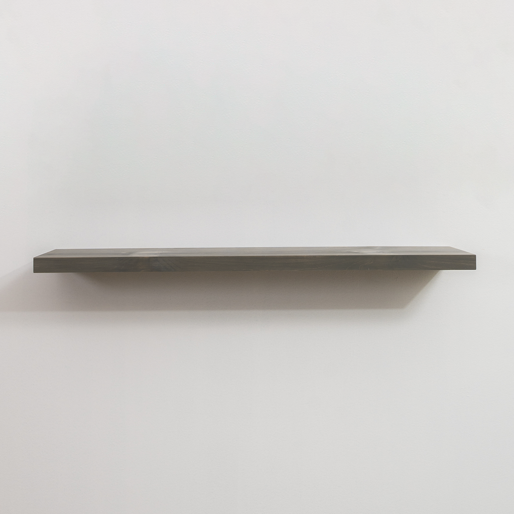 Gray floating shelf on a white wall