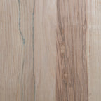 Close-up of a wooden unfinished ash surface with a natural grain pattern
