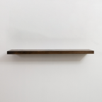 Wooden floating shelf on a white wall