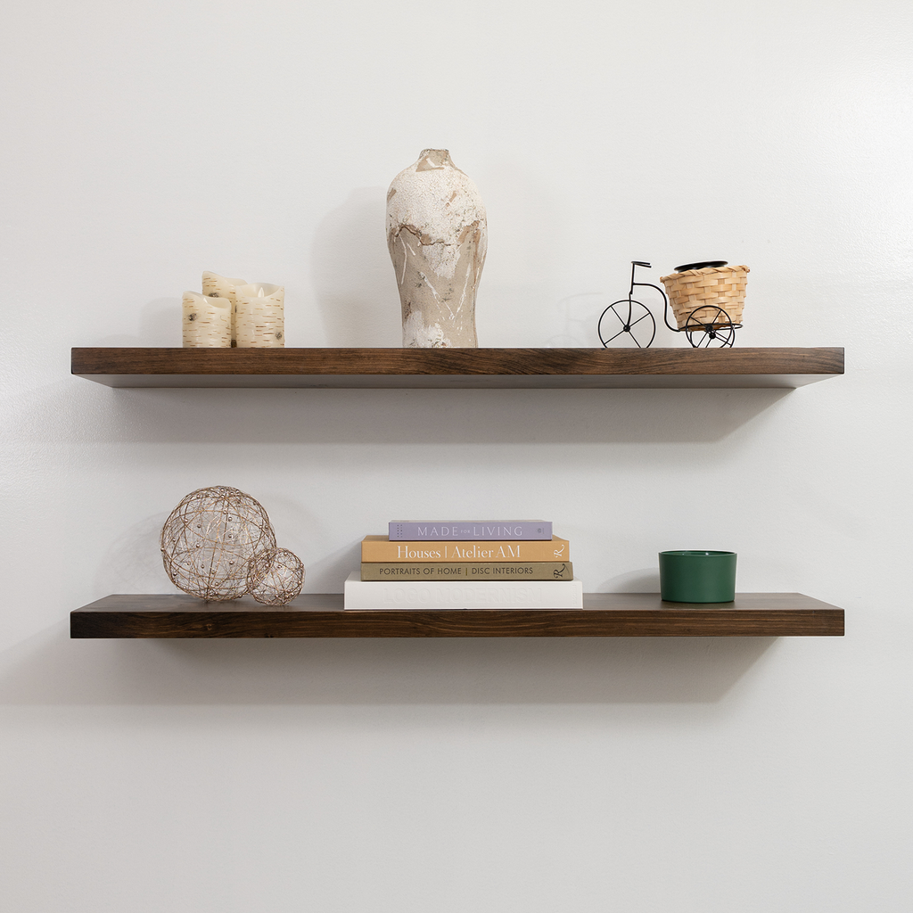 Two wooden shelves with decorative items against a white wall
