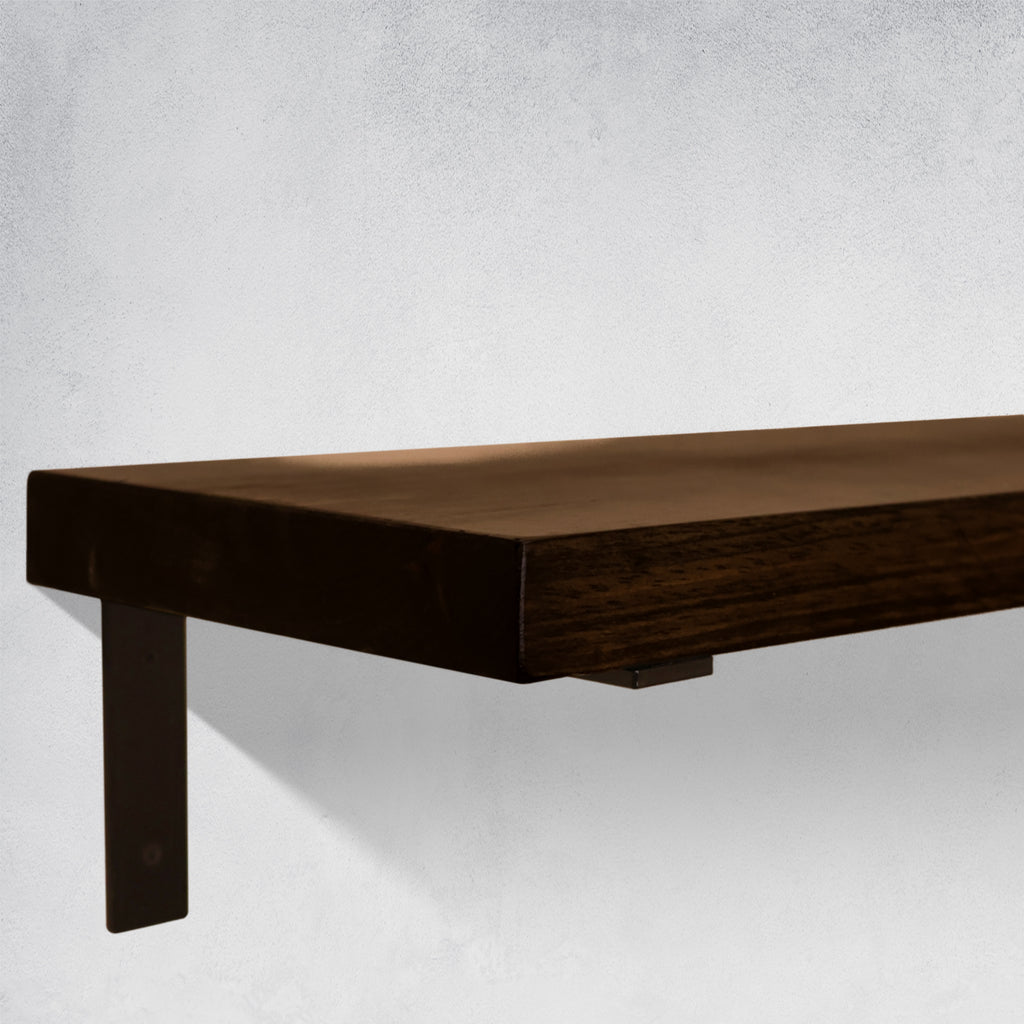 Close up of a Wooden Dark Brown Shelf with black supporting bracket on a light gray wall
