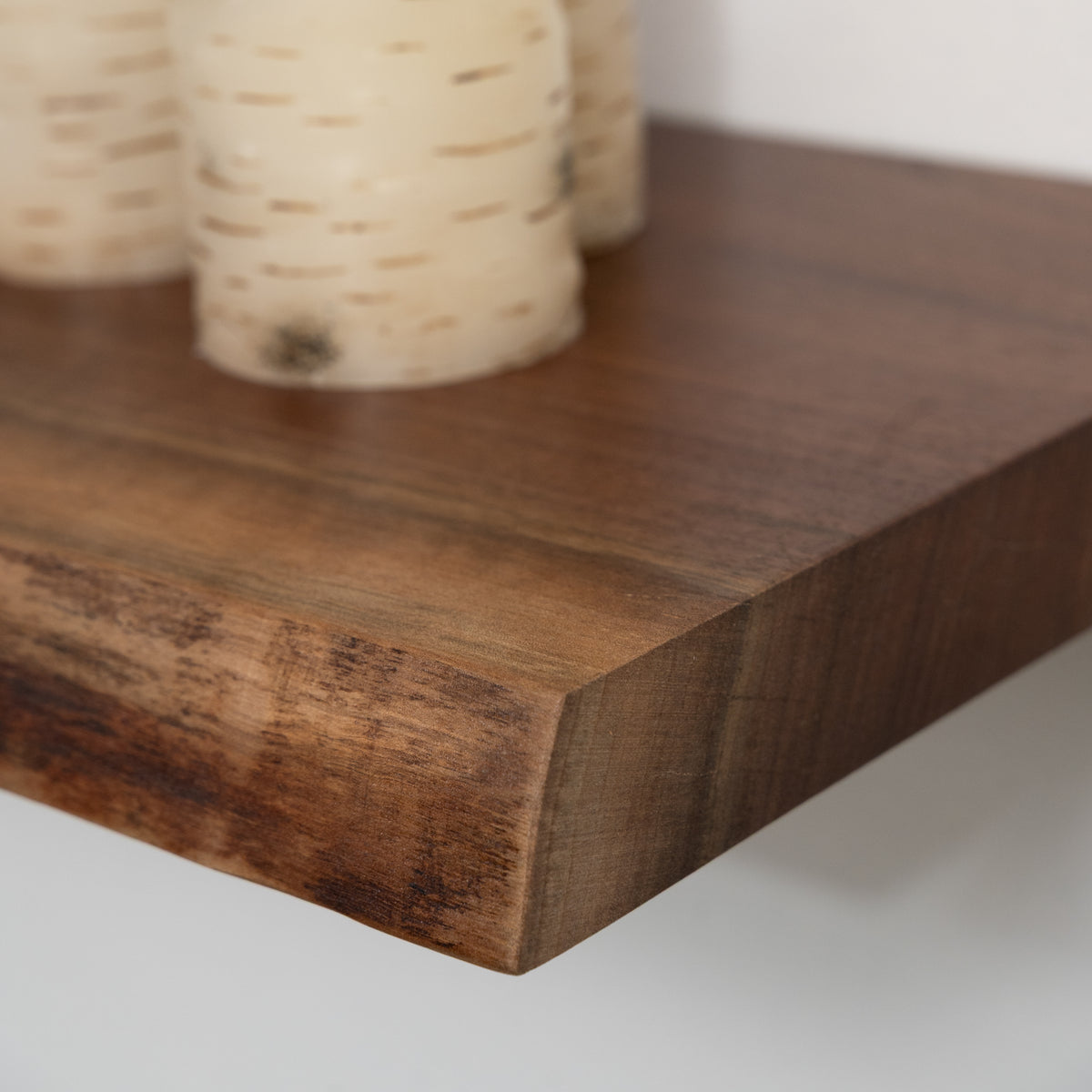 Close-up of a wooden shelf with a neutral background