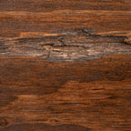 A close-up of a dark brown wood grain surface with visible natural texture, knots, and linear grain patterns.