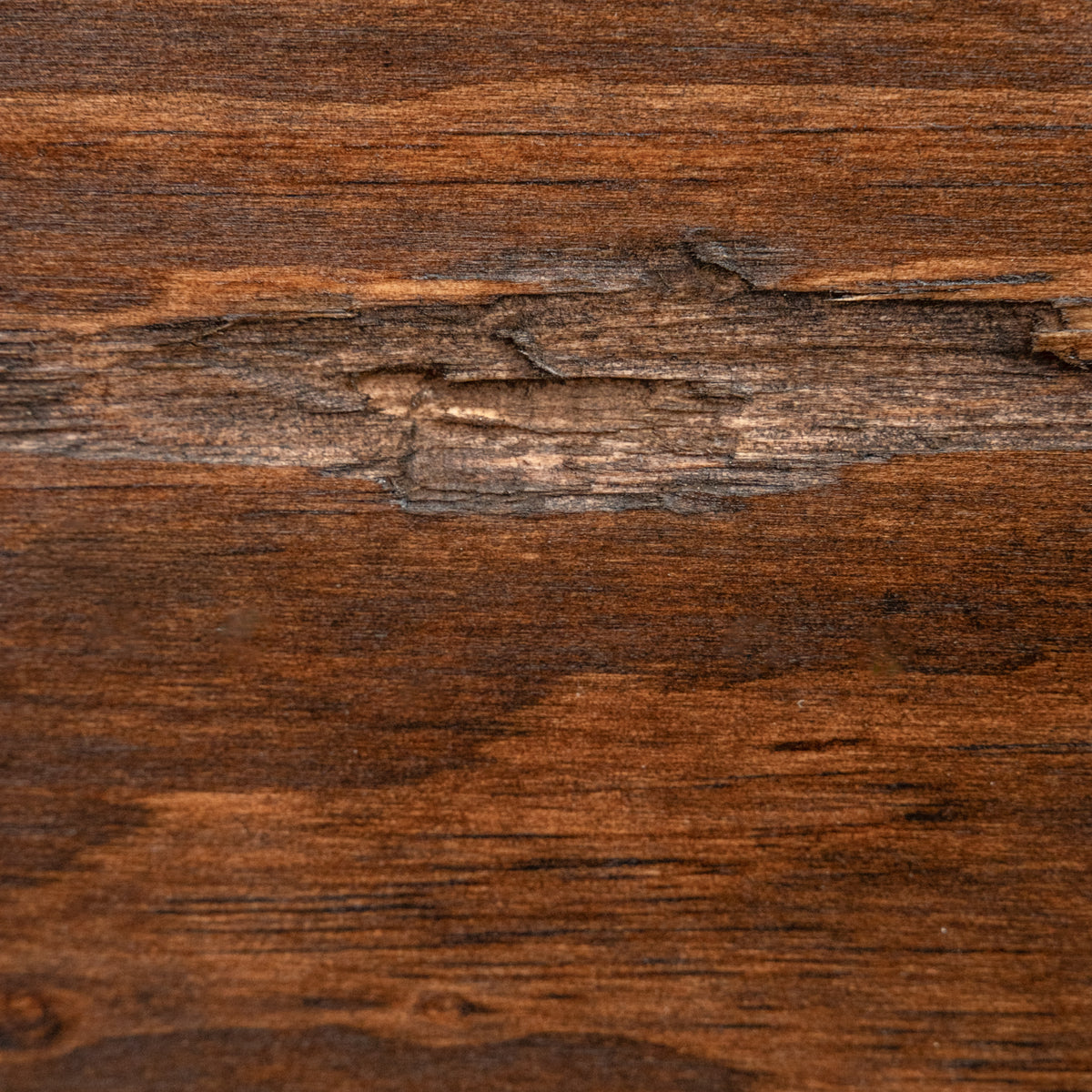 A close-up of a dark brown wood grain surface with visible natural texture, knots, and linear grain patterns.