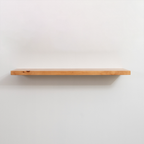 Wooden floating shelf on a white wall