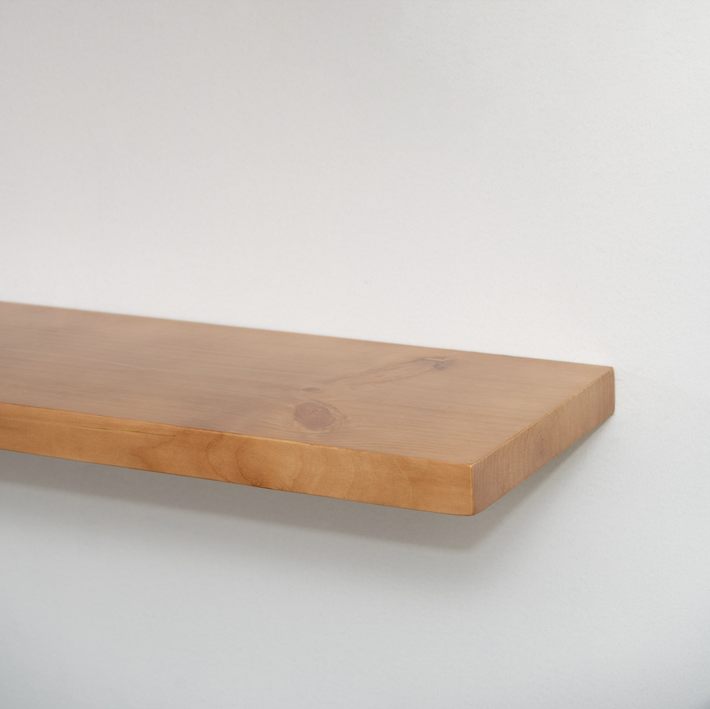Wooden floating shelf on a white background