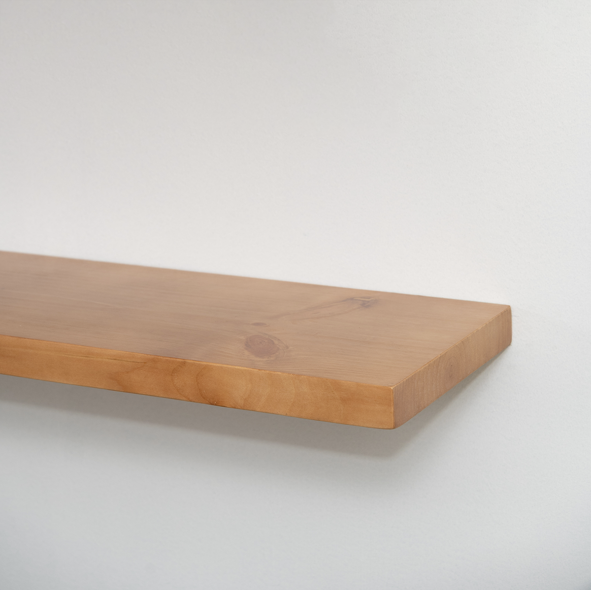 Wooden floating shelf on a white background