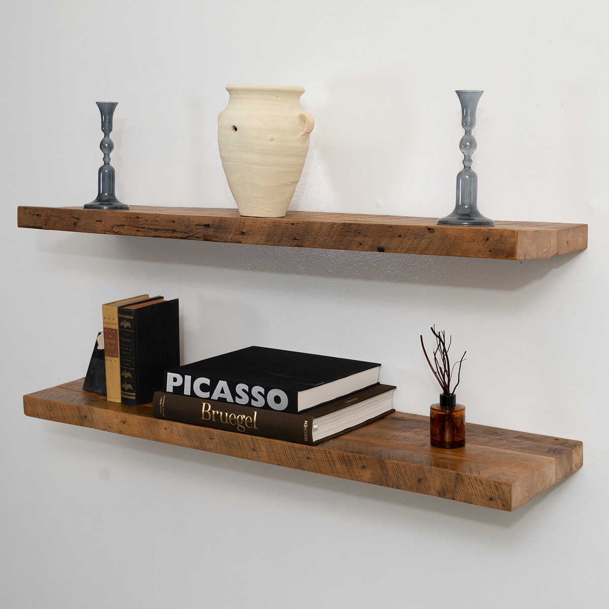 Wooden floating shelves with decorative items on a plain wall
