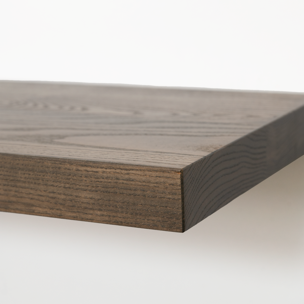 Close-up of a dark brown wood shelf or tabletop corner showing the grain and thickness against a clean white background.
