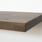 Close-up of a dark brown wood shelf or tabletop corner showing the grain and thickness against a clean white background.