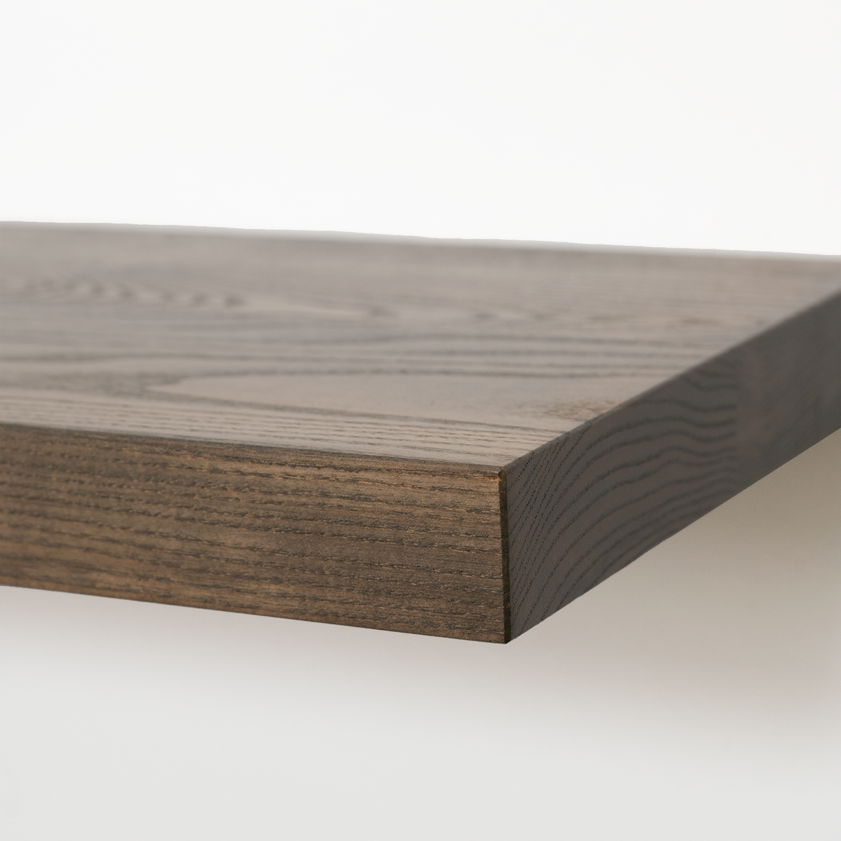 Close-up of a dark brown wood shelf or tabletop corner showing the grain and thickness against a clean white background.