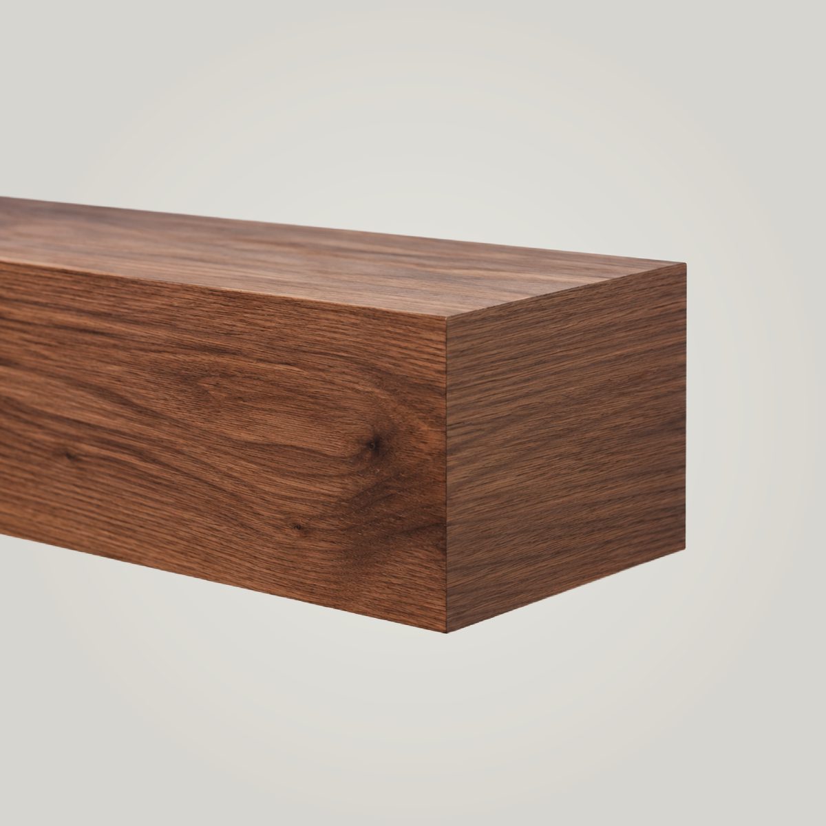 close up of a brown walnut fireplace mantel on a light background