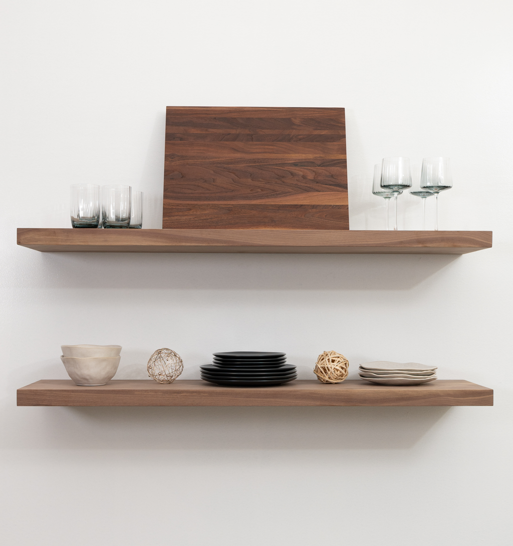 Wooden shelves with decorative items on a white wall