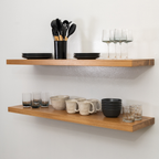 Wooden white oak floating shelves with kitchenware on a white wall