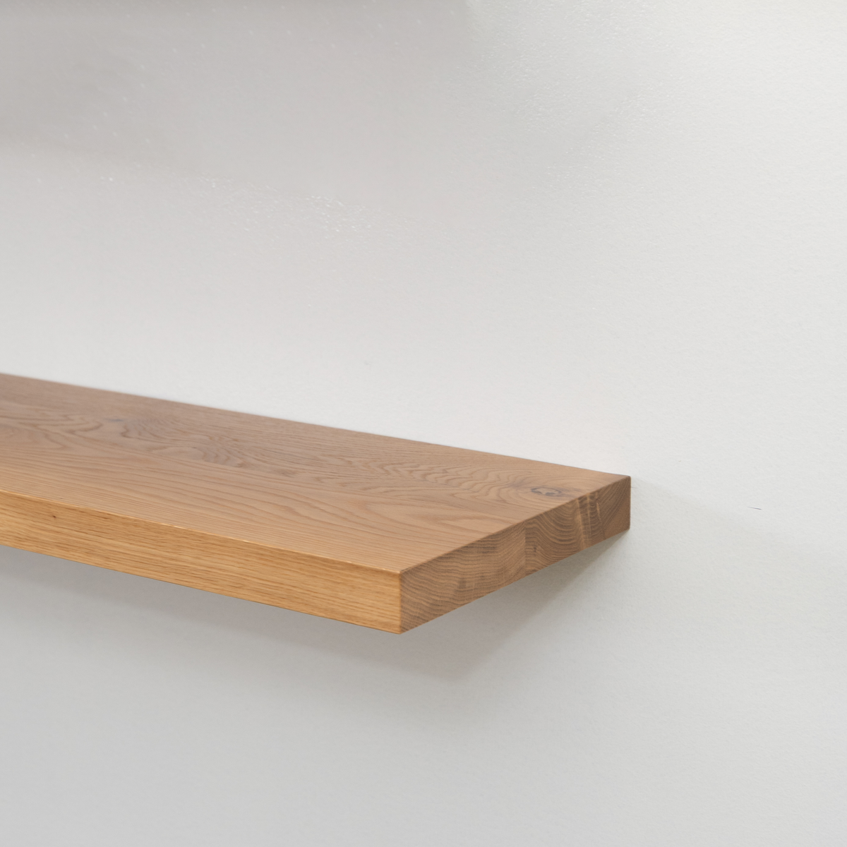 Wooden white oak floating shelf on a white background