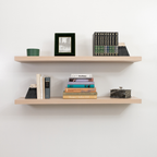 Two wooden floating shelves with books and decorative items against a white wall
