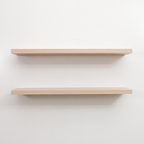 Two wooden floating shelves on a white wall