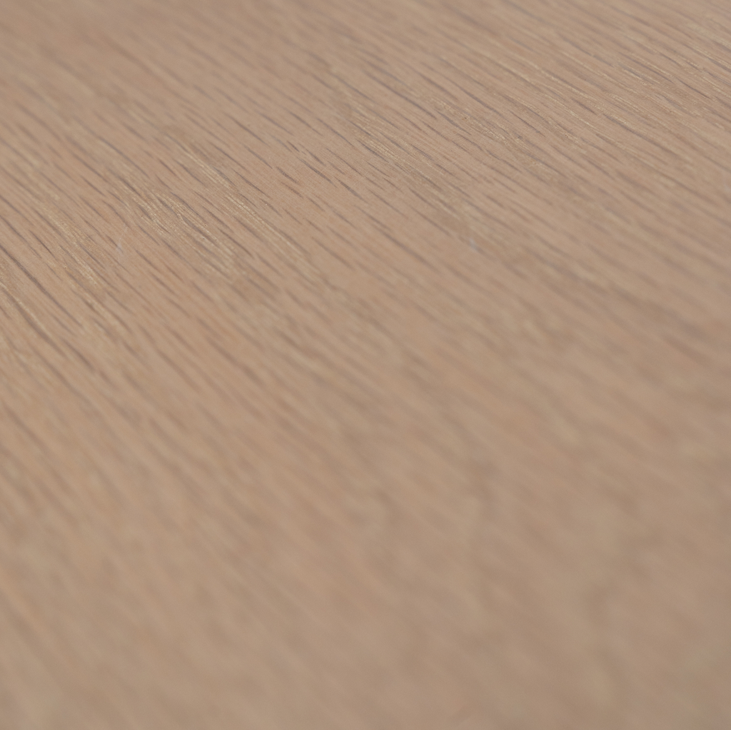 Close-up of a wooden surface with a light brown color and visible grain pattern.