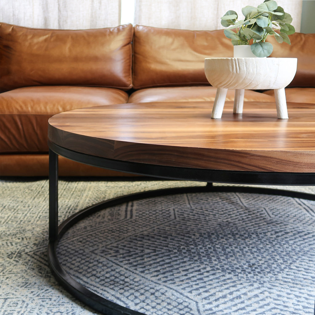 Round Wood Walnut Coffee Table with Black Metal Base in Living Room