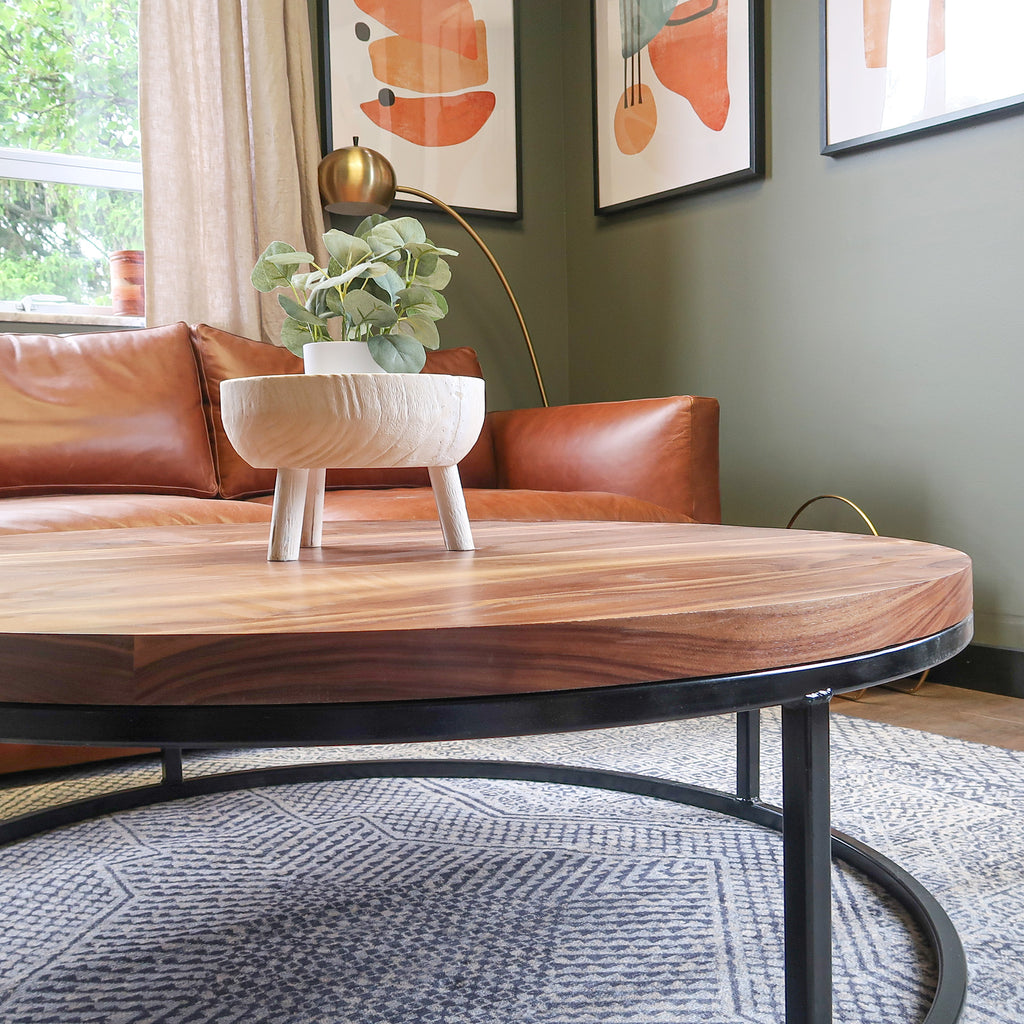 Large Round Wood Walnut Coffee Table with Black Metal Base in Living Room