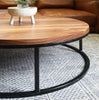 Modern Round Wood Walnut Coffee Table with Black Metal Base in Living Room