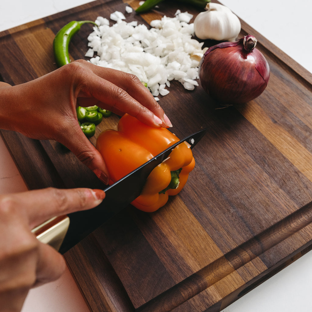 Cutting of Pepper with Knife on Custom Walnut Wood Cutting Board